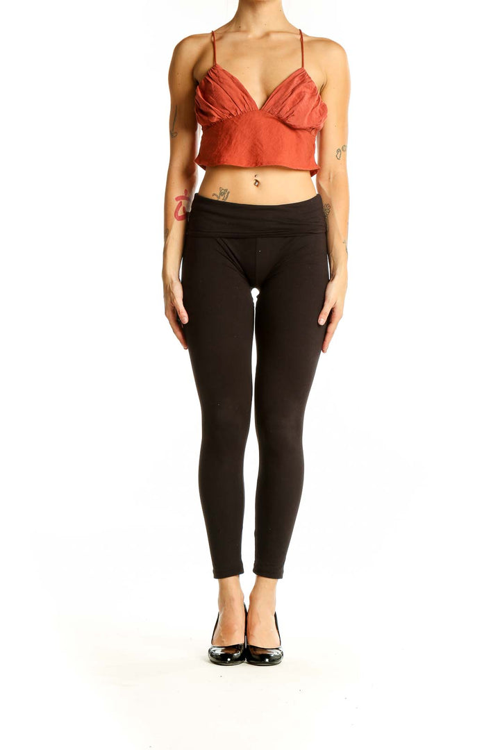 Front view of rust-colored cropped cami top with gathered bust