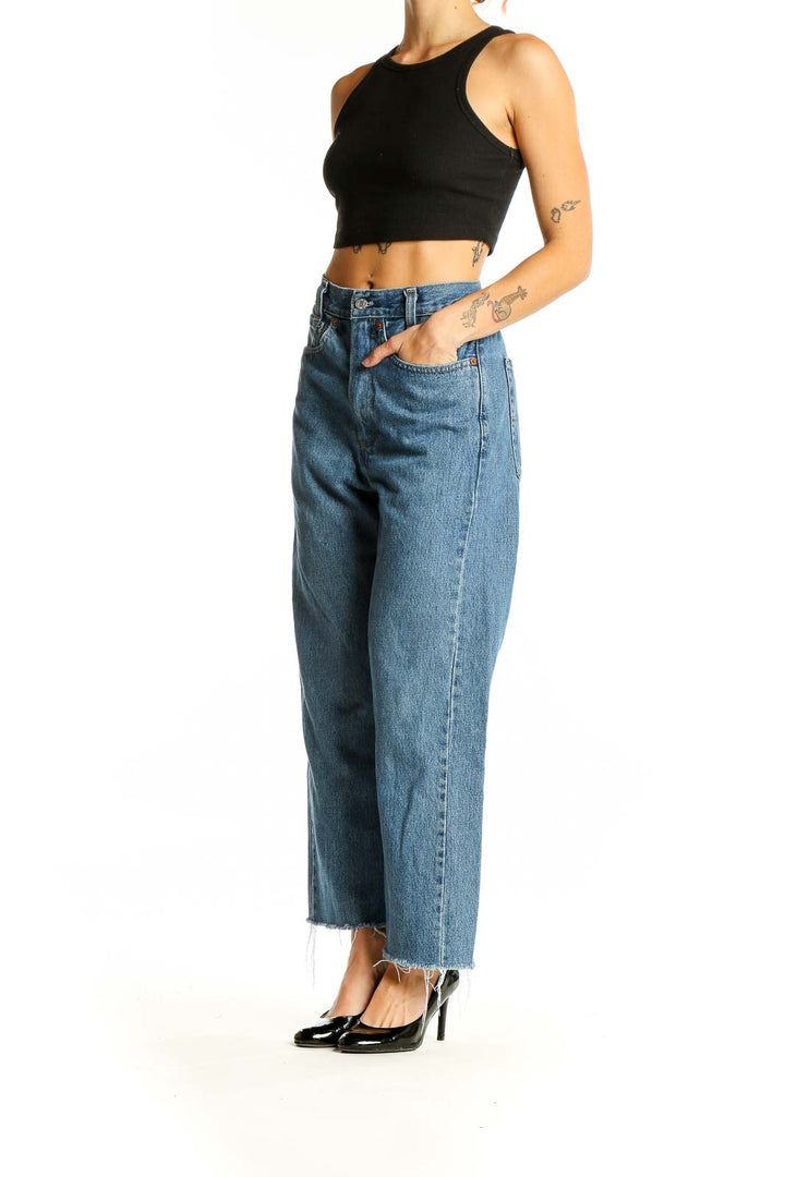 Front view of Levi's blue wide-leg jeans with frayed hem