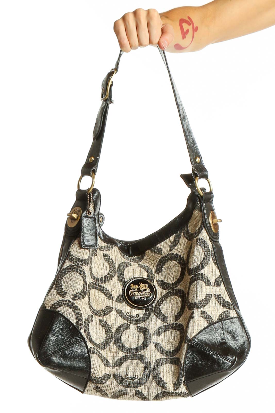 Front view of Coach signature print hobo bag in black and beige