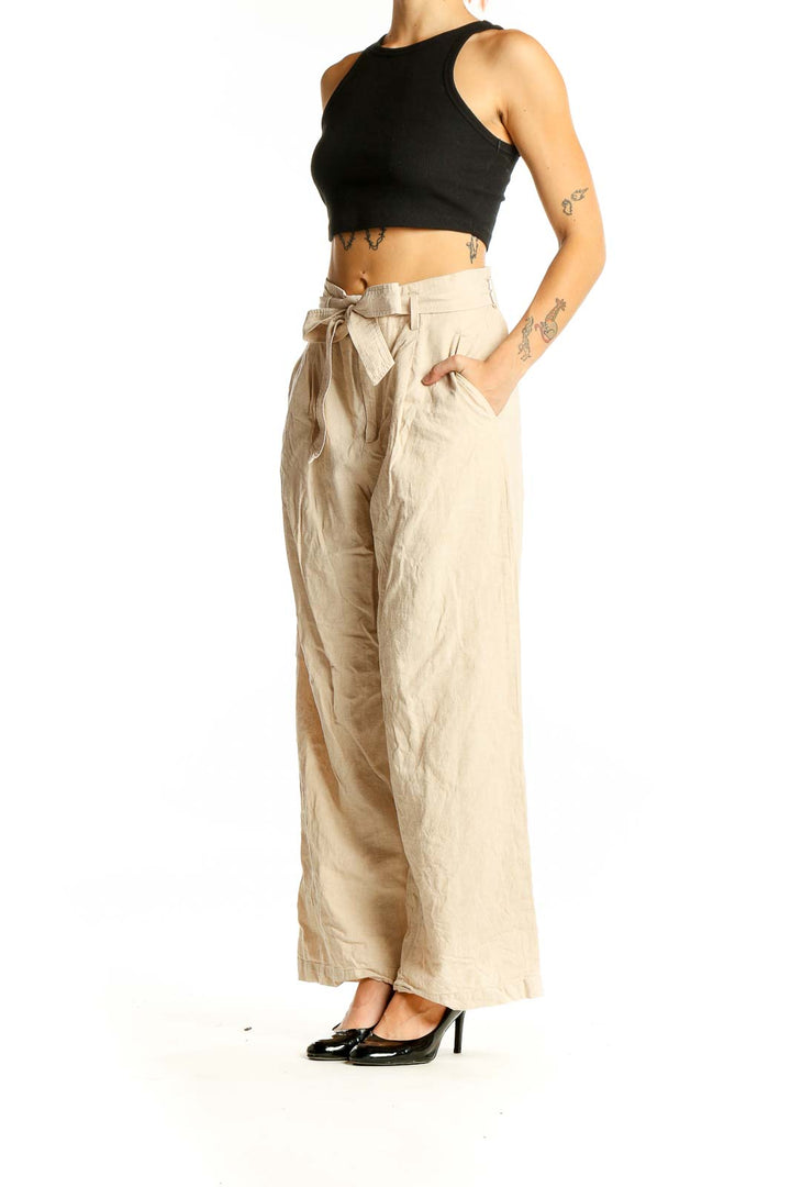 Front view of Uniqlo beige linen wide-leg pants with tie waist