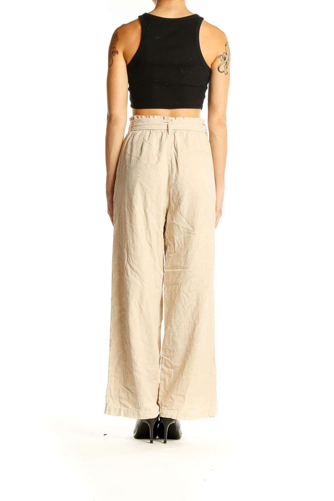 Back view of Uniqlo beige linen wide-leg pants showing relaxed fit