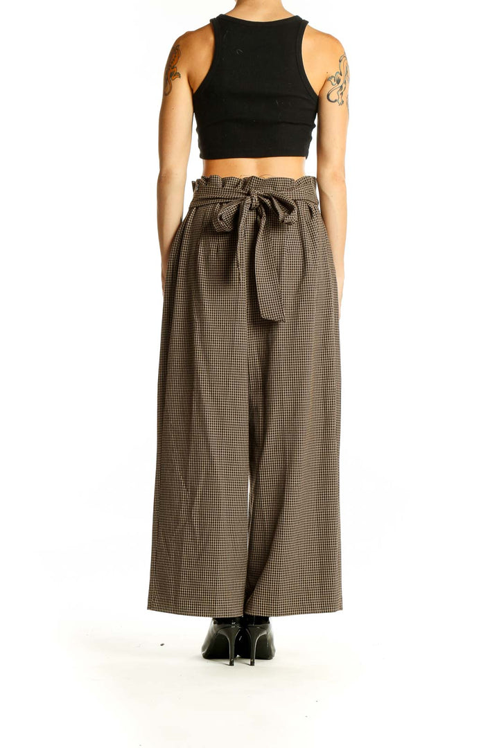 Back view of Zara brown houndstooth wide-leg trousers showing tie-waist detail