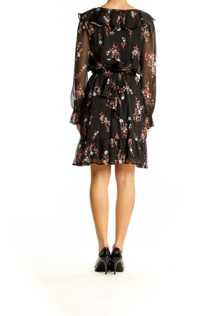 Side view of SilkRoll black floral wrap mini dress showing flowy skirt and wrap design