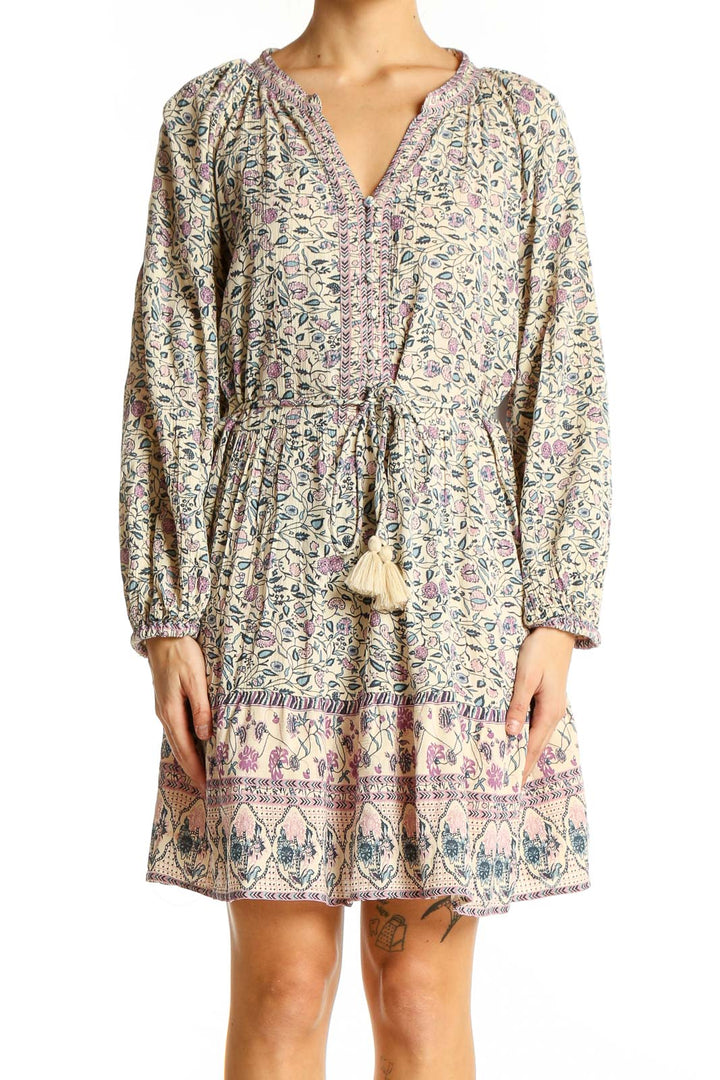 Front view of SilkRoll beige floral mini dress with V-neck and long sleeves