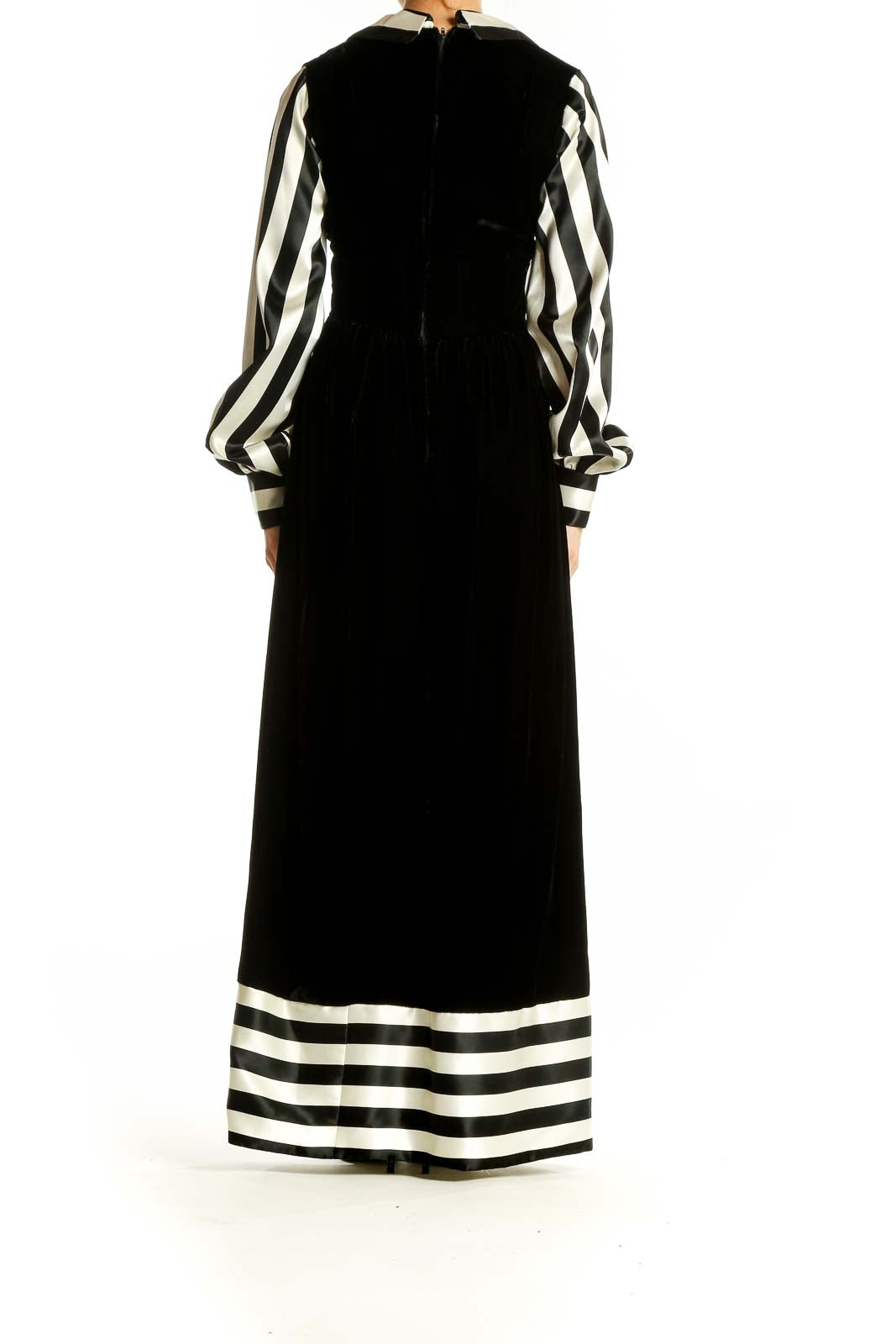 Side view of SilkRoll Black and White Striped Velvet Maxi Dress showing striped hem