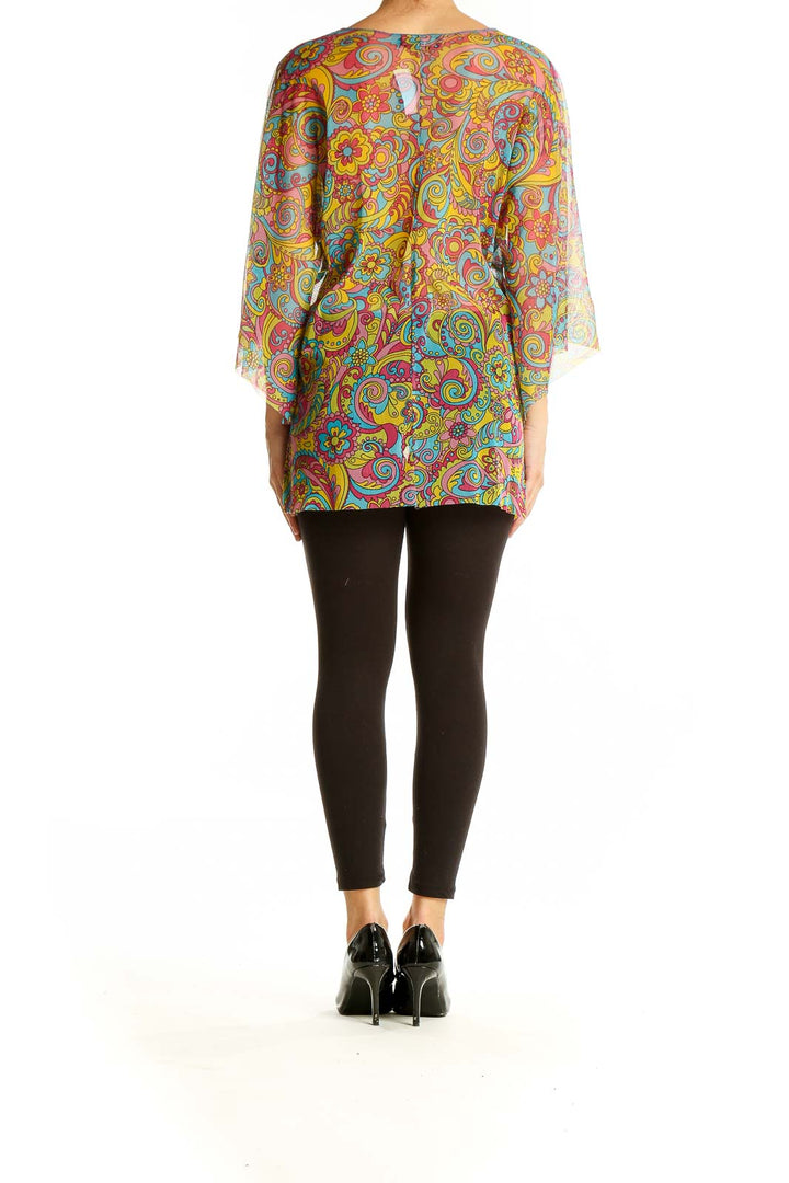 Back view of Alba Chiara Multicolor Psychedelic Print Tunic Top on model with black leggings