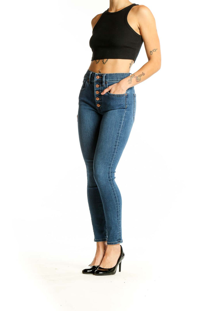 Front view of Express blue high-waisted skinny jeans with button-fly