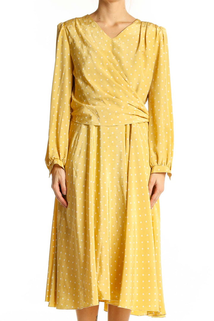 Front view of yellow polka dot wrap midi dress by SilkRoll