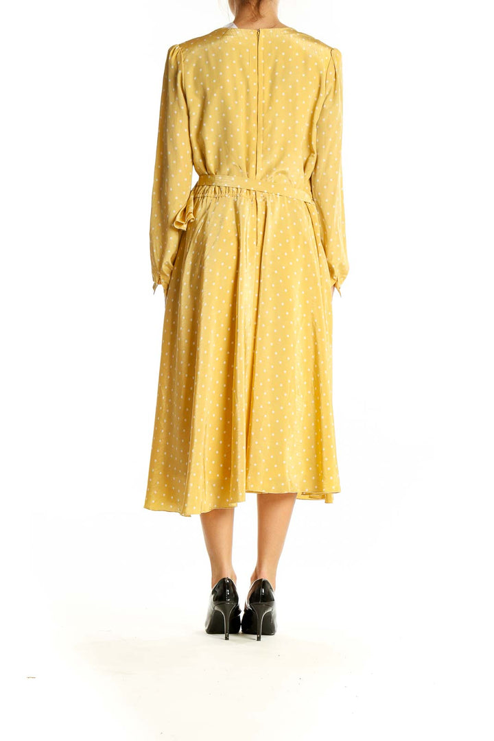 Side view of yellow polka dot wrap midi dress by SilkRoll