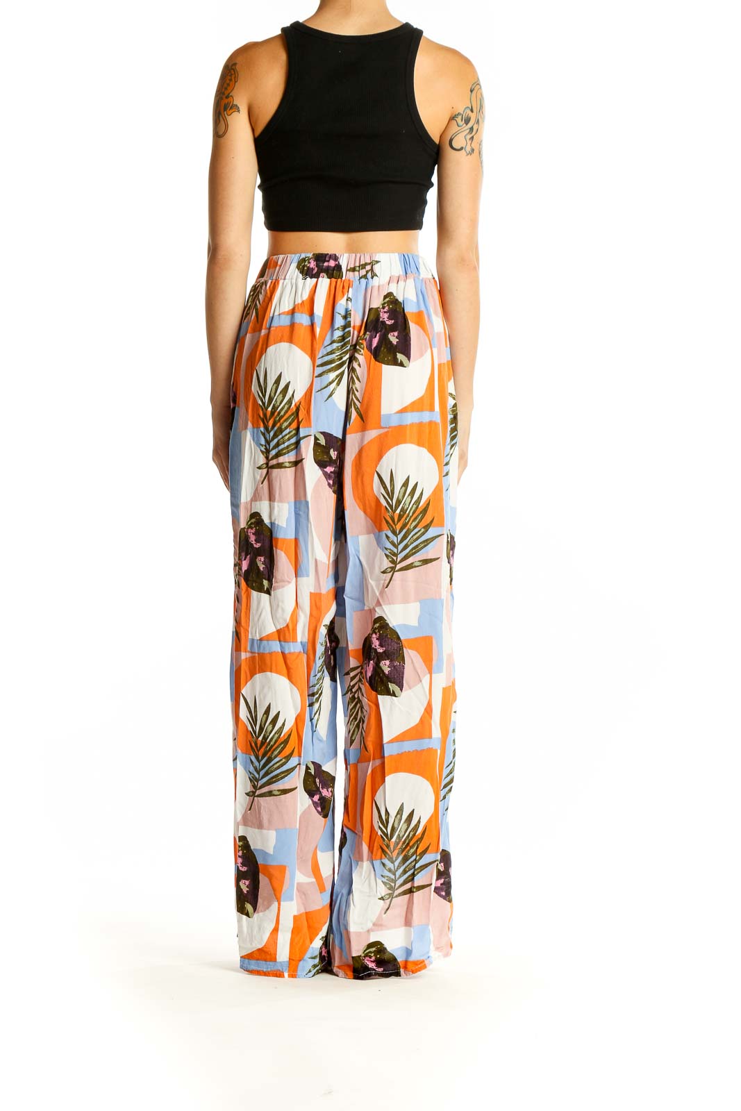 Side view of Thread Story wide-leg pants showing tropical print and side slit