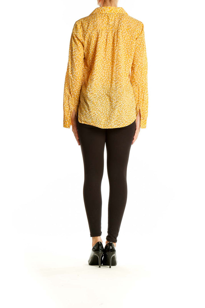 Side view of yellow floral cotton button-up shirt from LOFT Outlet on model