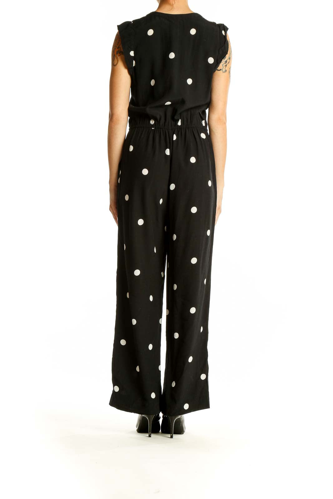 Side view of LOFT black polka dot sleeveless jumpsuit