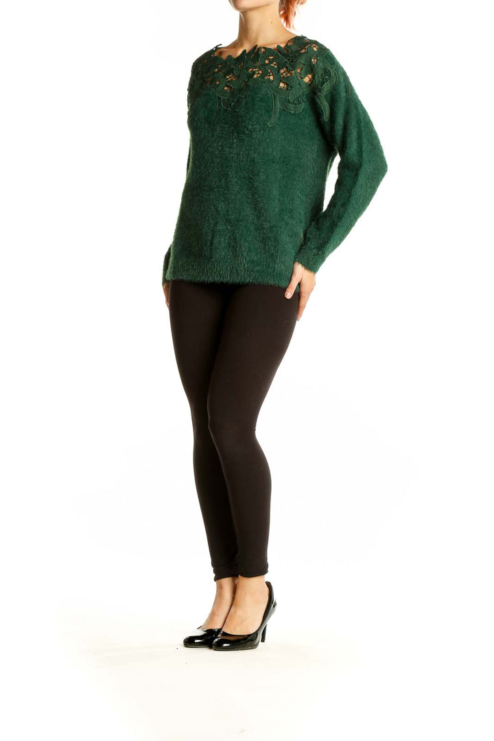 Front view of green fuzzy nylon sweater with lace cutout neckline