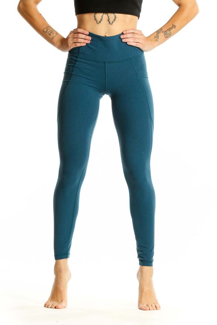 Front view of teal Athleta high-waisted performance leggings