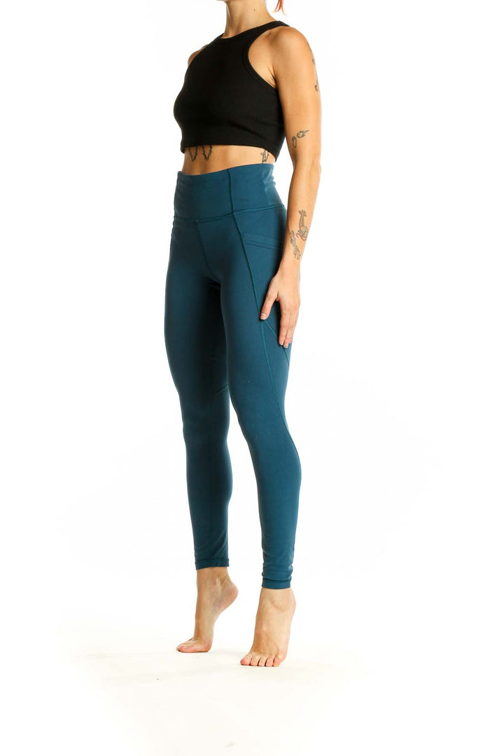 Front view of teal Athleta high-waisted performance leggings