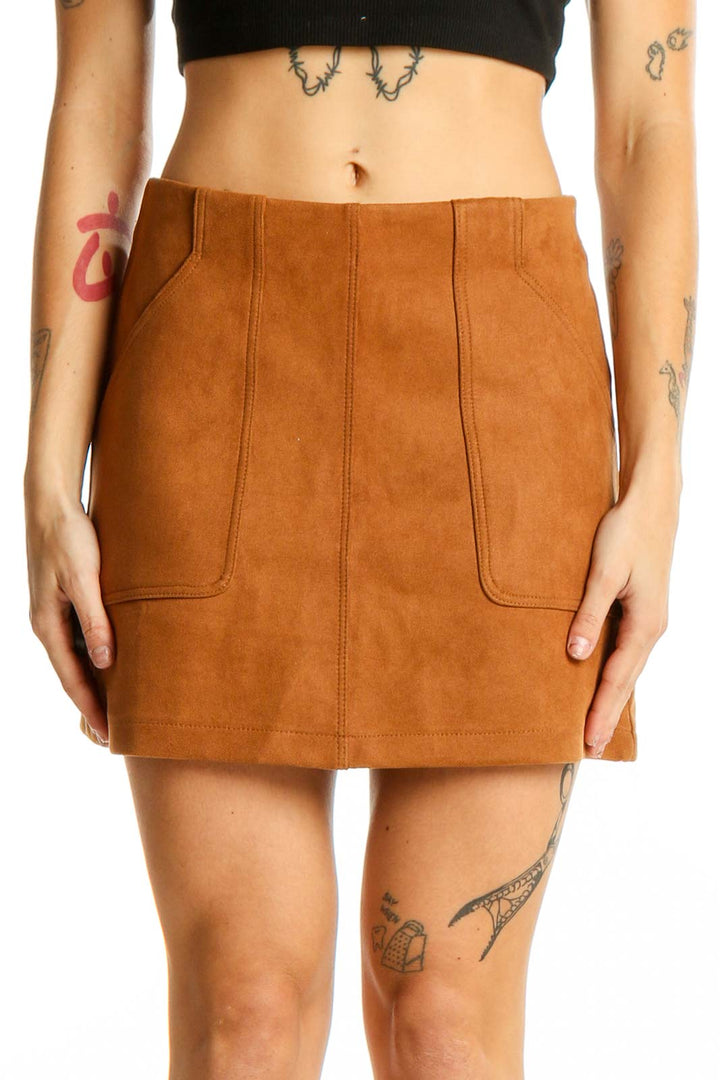 Front view of camel suede mini skirt with front pockets