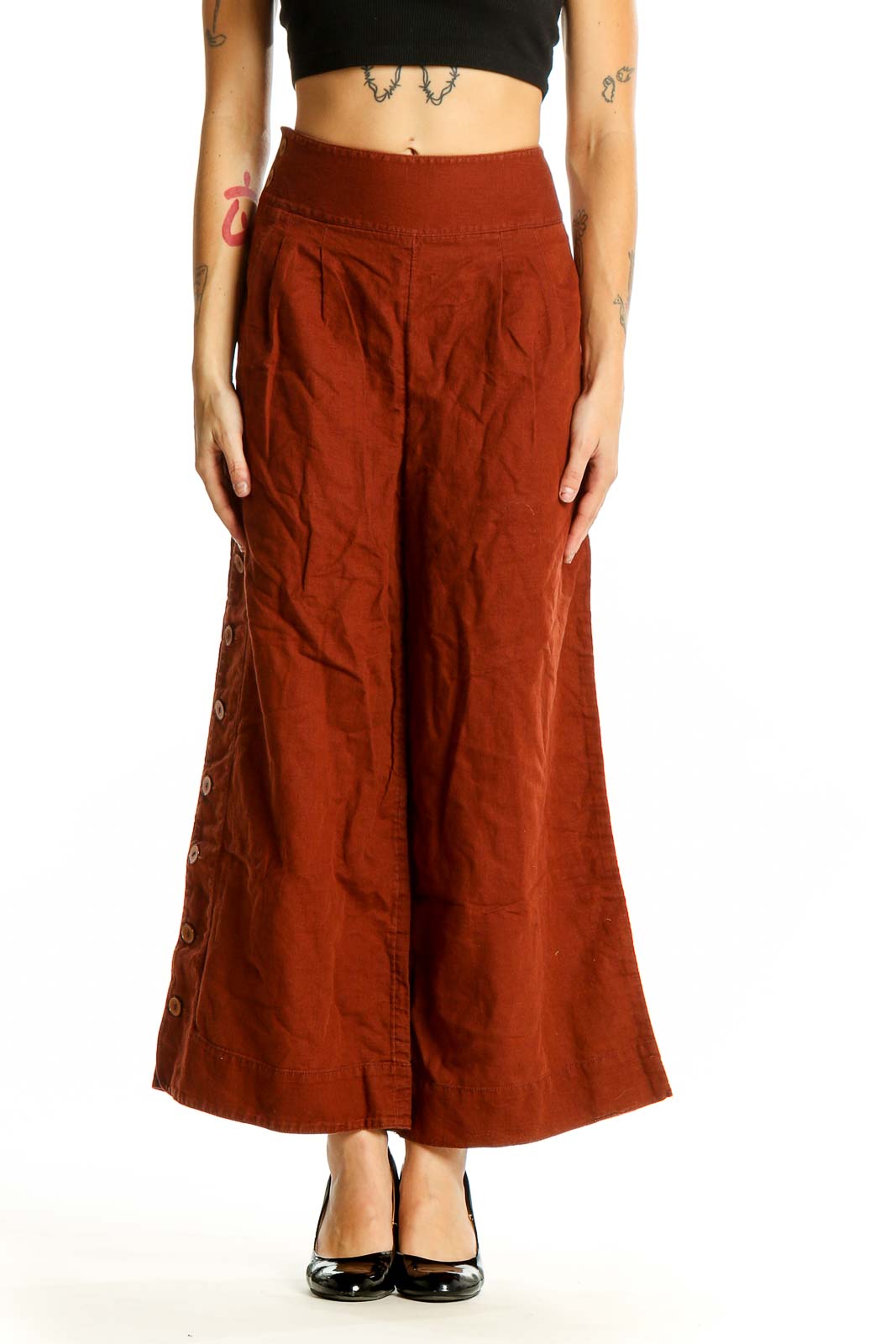 Front view of Anthropologie rust-colored wide-leg pants with side buttons