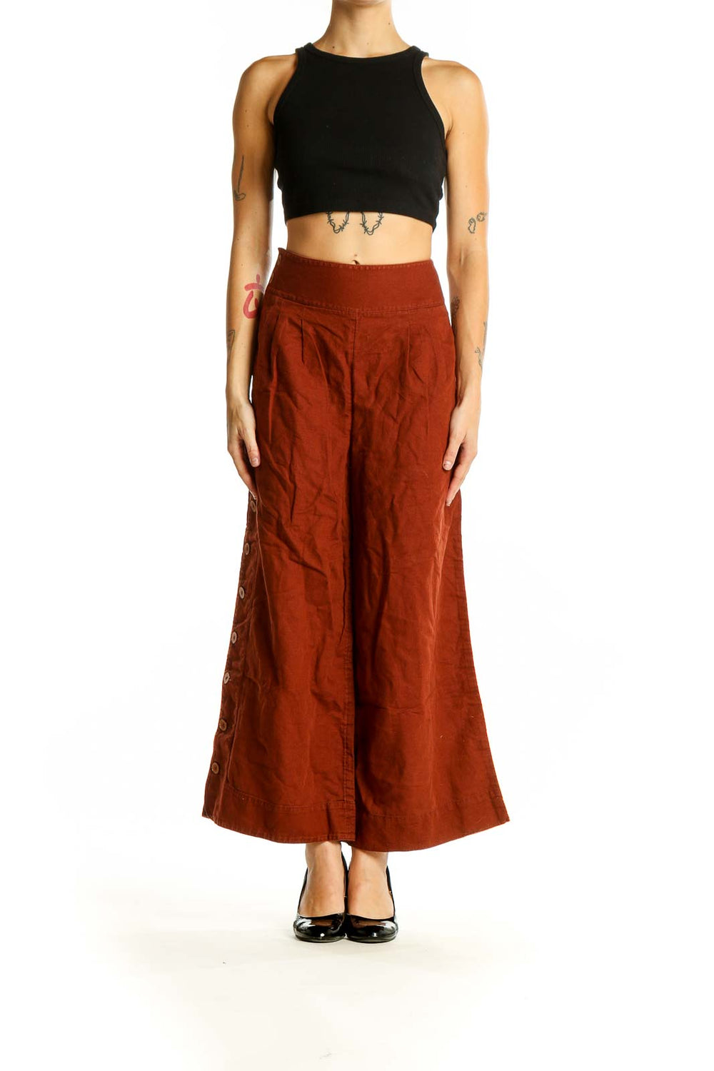 Front view of Anthropologie rust-colored wide-leg pants with side buttons