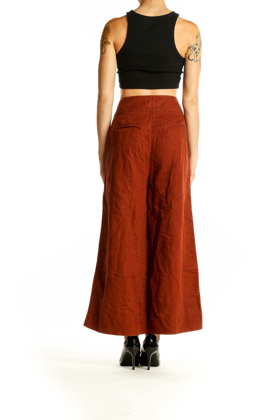 Side view of Anthropologie rust-colored wide-leg pants on model