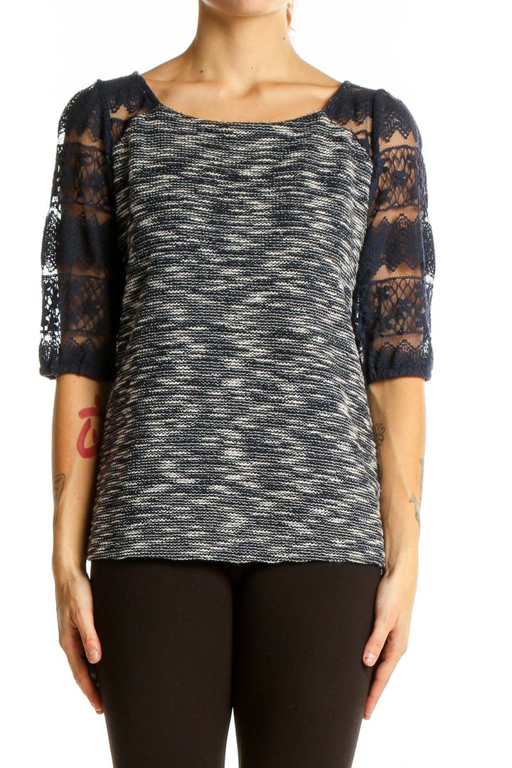 Front view of Anthropologie black and white marled top with navy lace sleeves