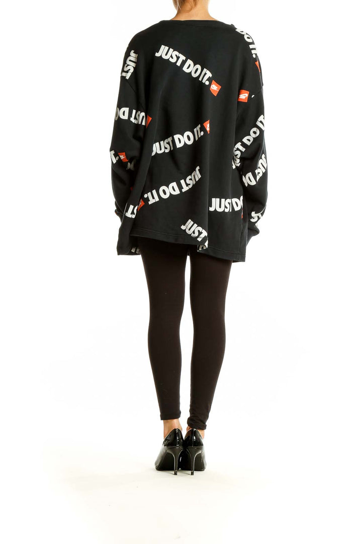 Side view of black Nike oversized sweatshirt with 'Just Do It' print