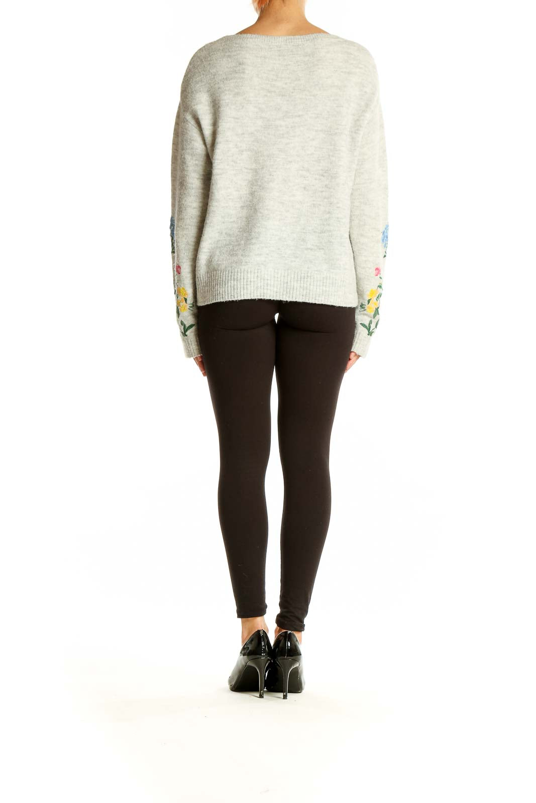 Side view of SilkRoll gray knit sweater showcasing floral embroidery detail