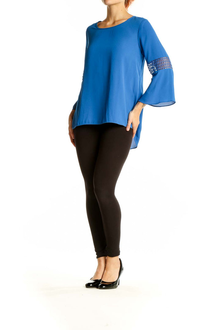 Front view of blue EST.1946 polyester blouse with lace-insert bell sleeves