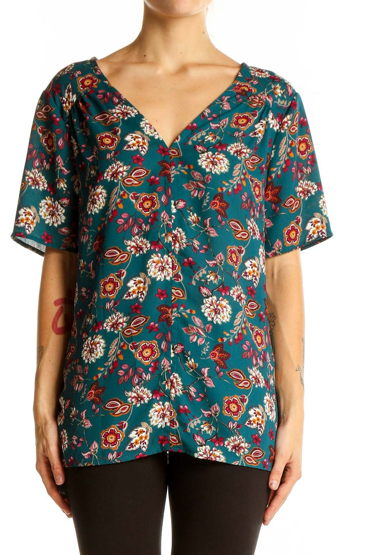 Front view of Pleione teal floral V-neck short sleeve blouse