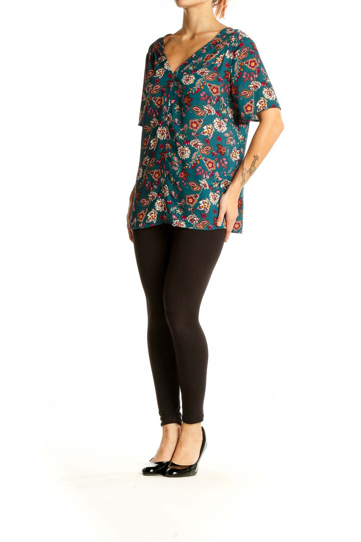 Front view of Pleione teal floral V-neck short sleeve blouse