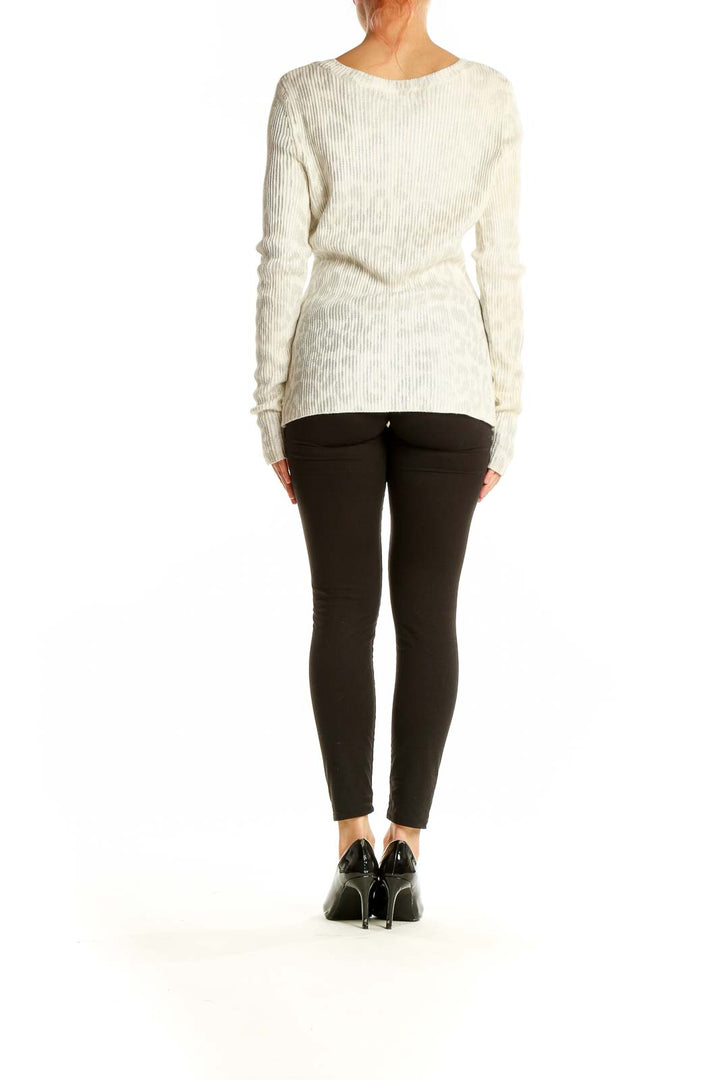 Side view of cream ribbed long sleeve sweater by Saks Fifth Avenue on model