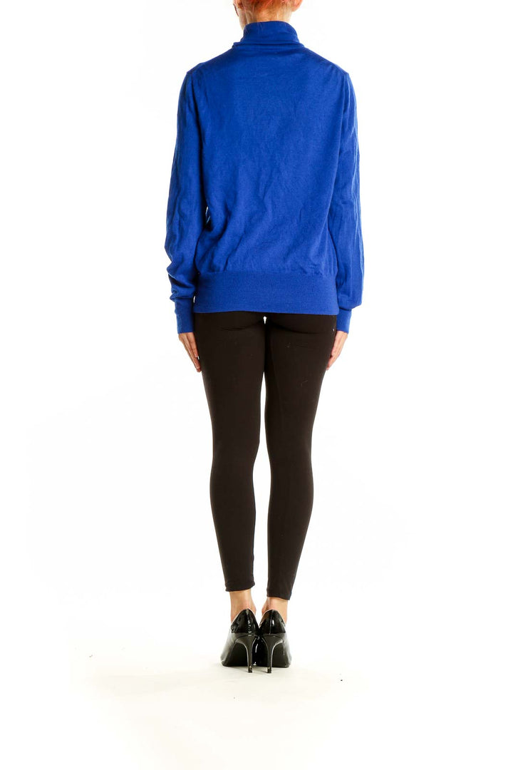 Back view of J.Crew royal blue turtleneck sweater on model with black pants