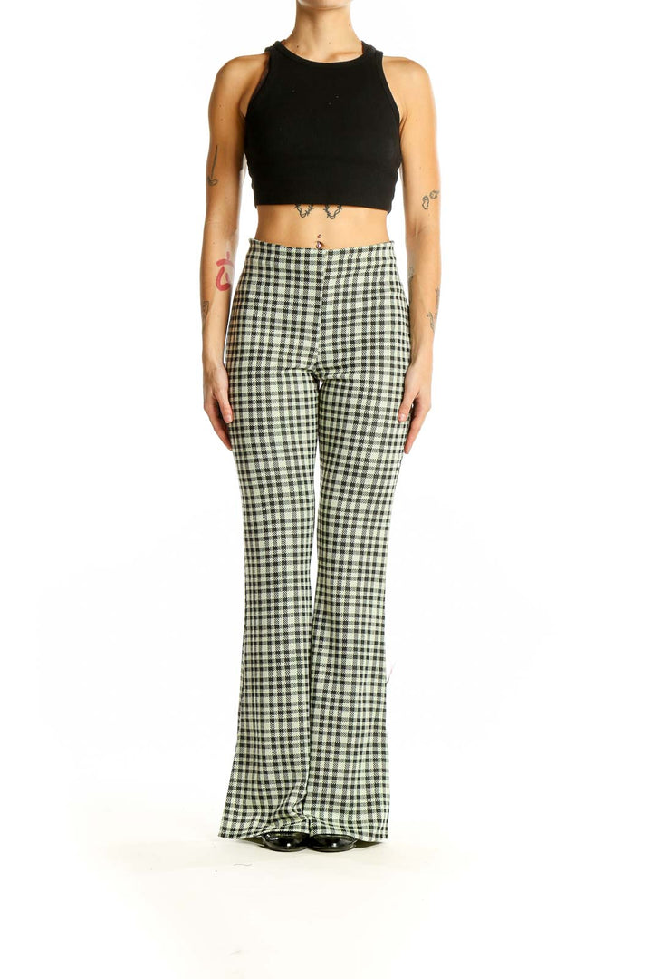 Front view of ASOS green gingham check flared pants on model