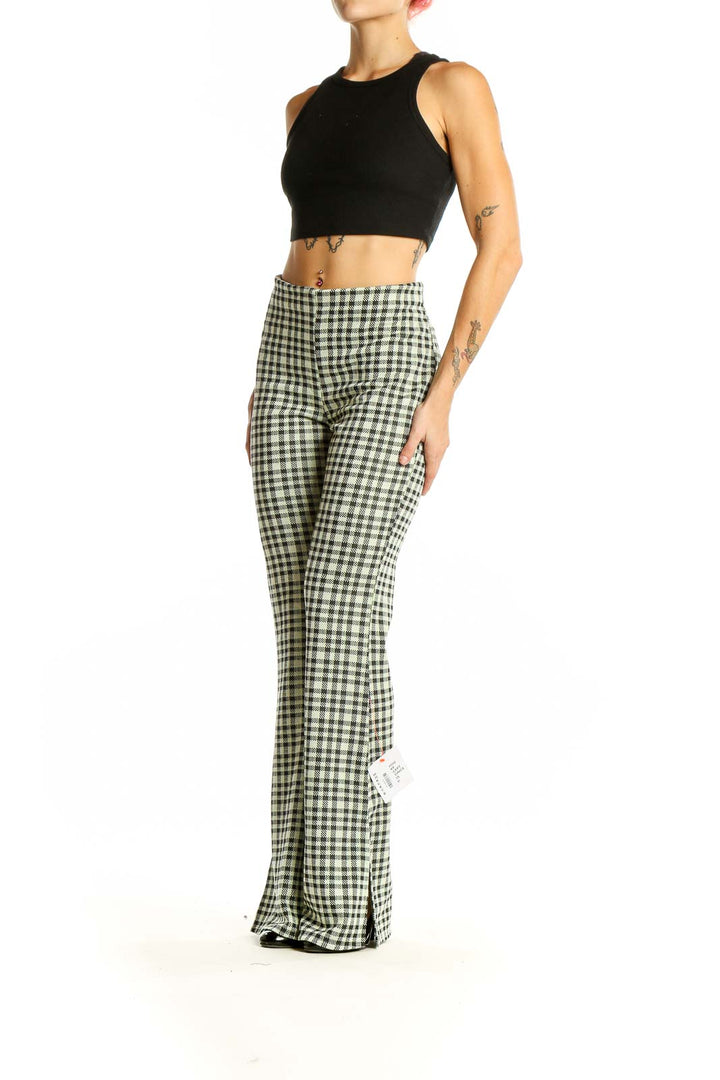 Front view of ASOS green gingham check flared pants on model