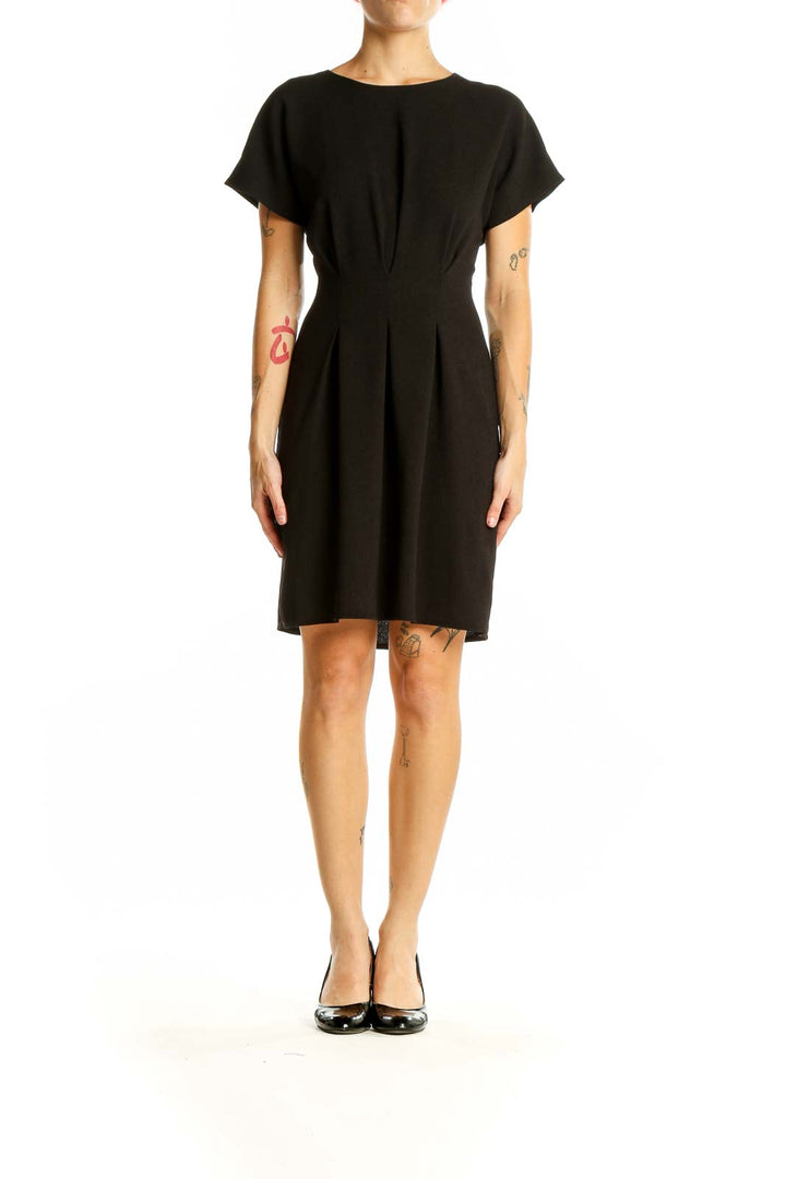 Front view of black ASOS mini dress with pleated waist and short sleeves