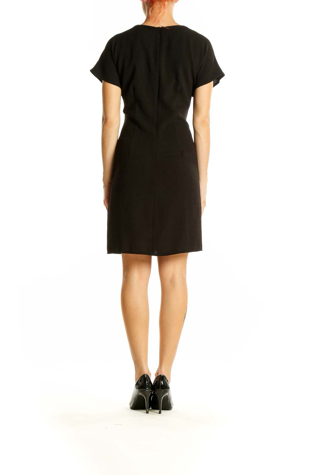 Back view of black ASOS mini dress showing sleek design and mini length