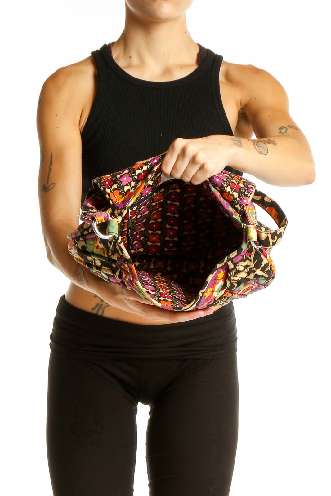 Side view of Vera Bradley multicolor floral quilted crossbody bag worn by model