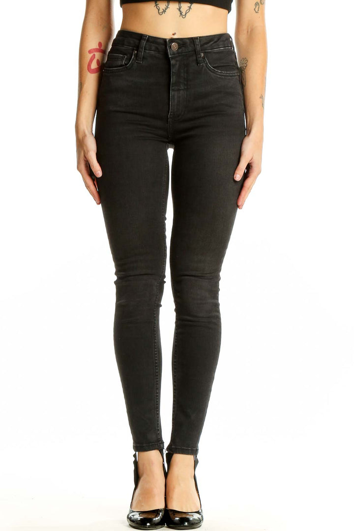 Front view of Free People black high-waisted skinny jeans on model