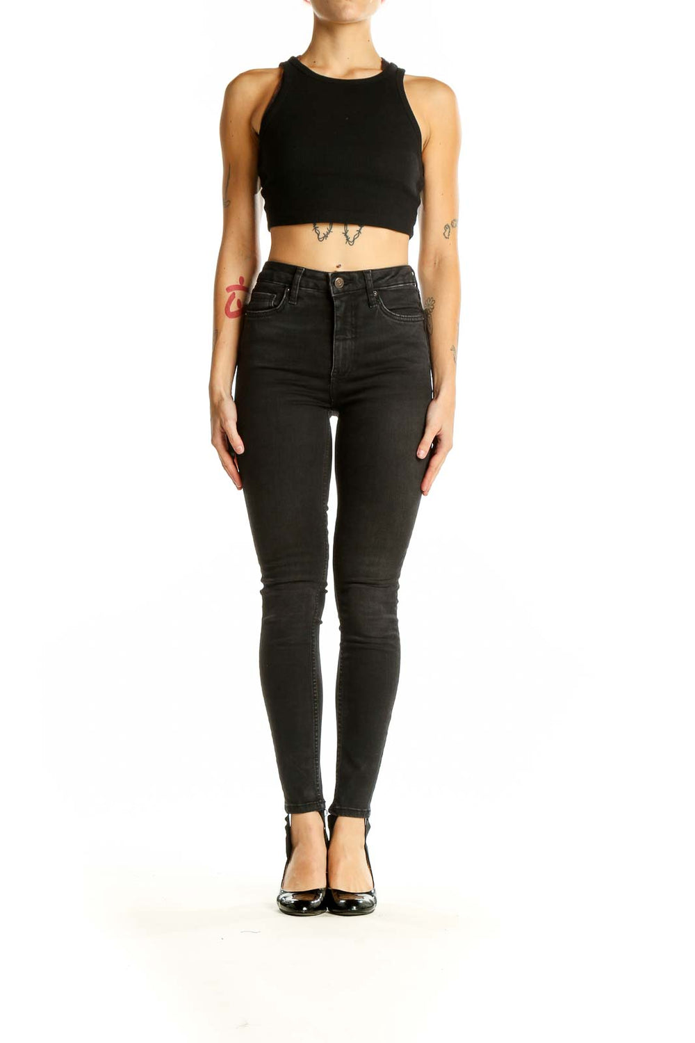 Front view of Free People black high-waisted skinny jeans on model