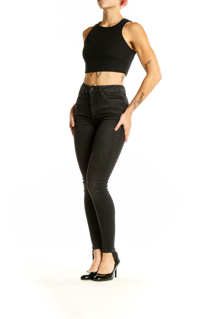 Front view of Free People black high-waisted skinny jeans on model