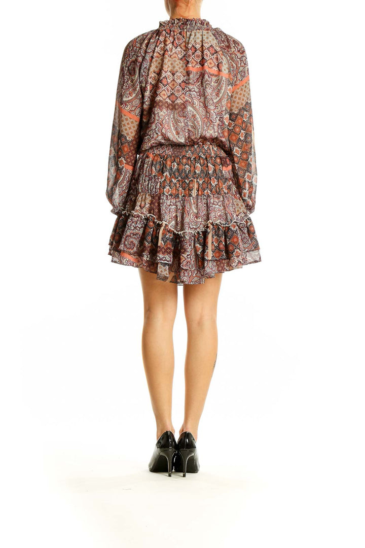 Side view of Fate brown paisley mini dress showing long sleeves and flowy silhouette