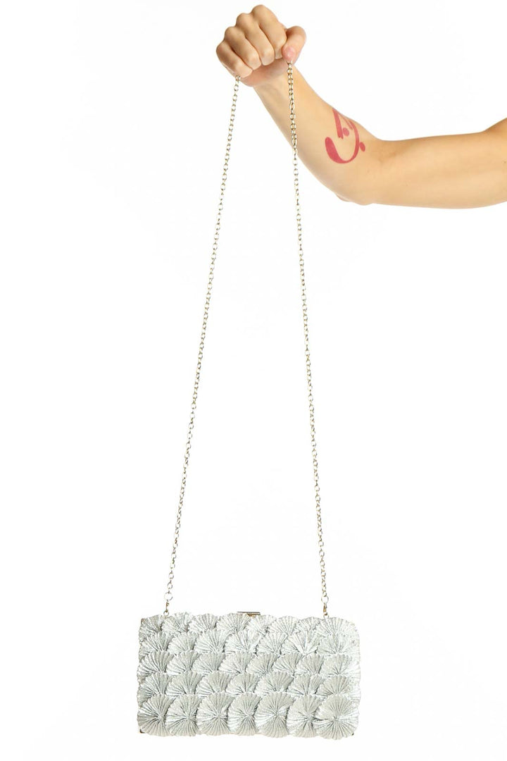 Front view of Kate Landry silver floral embellished clutch with chain strap