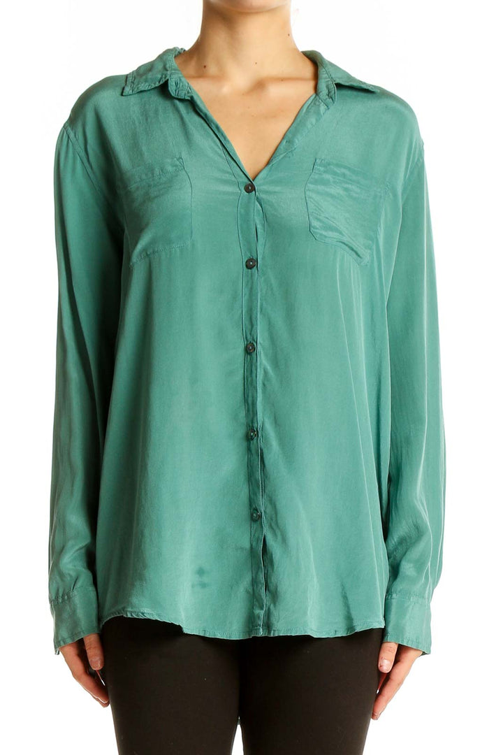 Front view of green silk button-down blouse by Calypso