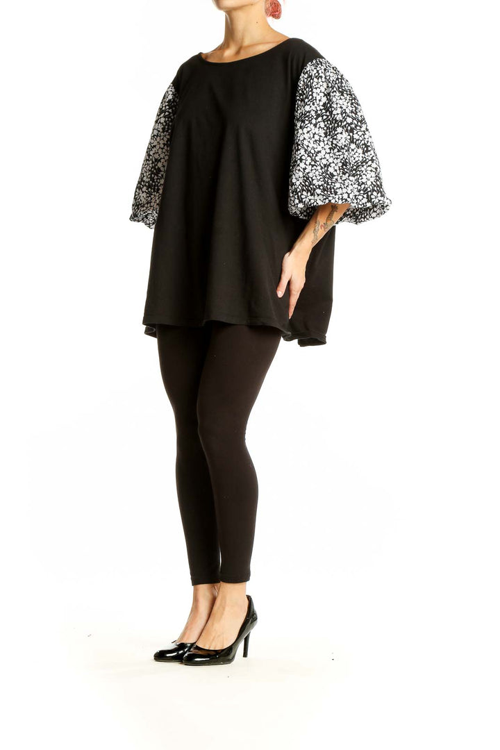 Front view of Talbots black top with floral print balloon sleeves