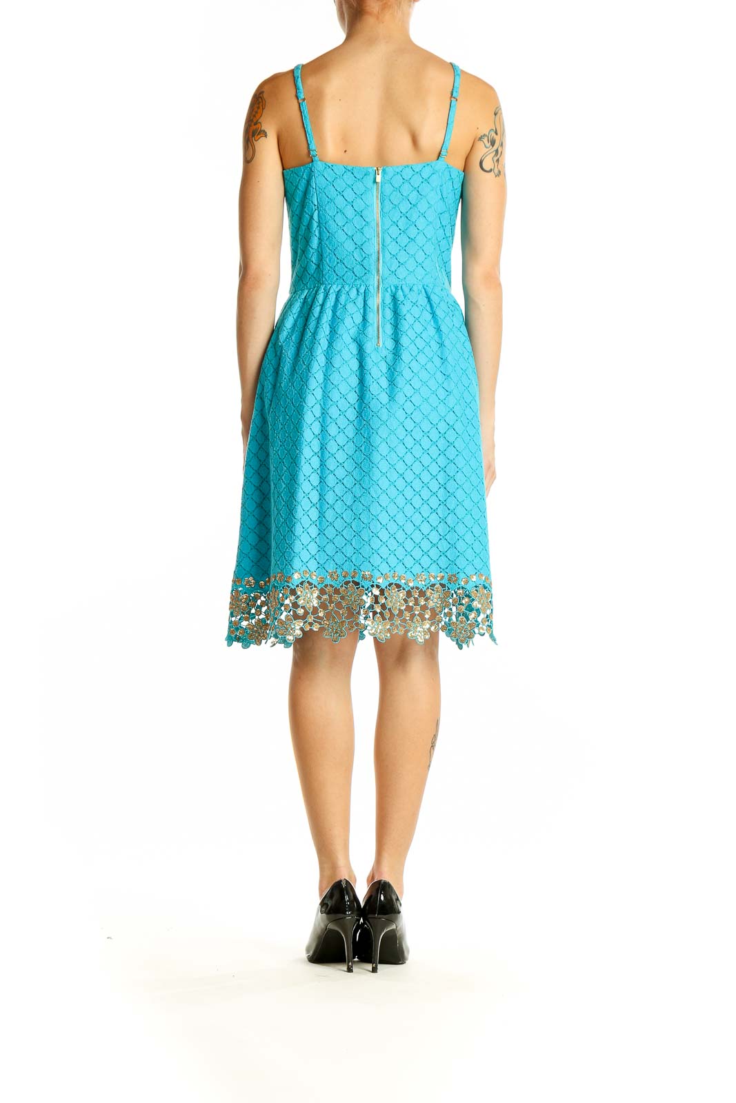 Side view of Lilly Pulitzer turquoise sleeveless dress showing flared skirt and lace trim