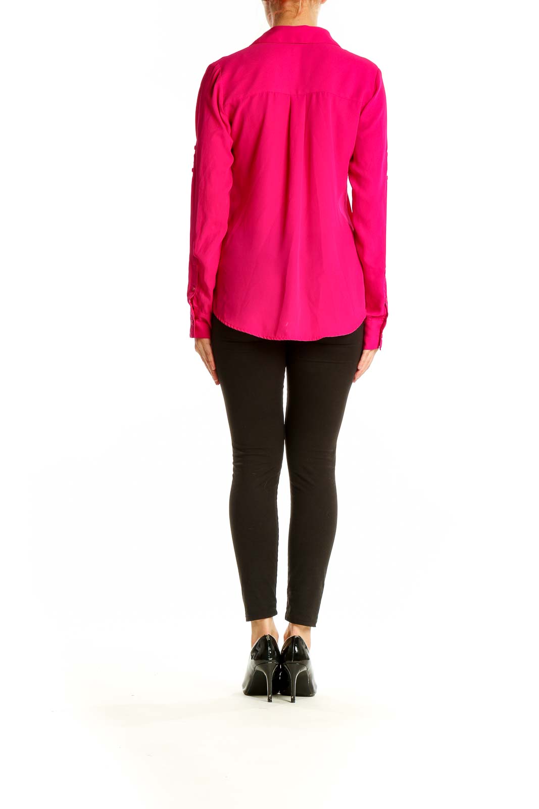 Side view of woman wearing hot pink Express blouse with black pants