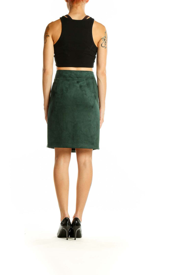 Side view of model wearing LOFT forest green suede pencil skirt with black top