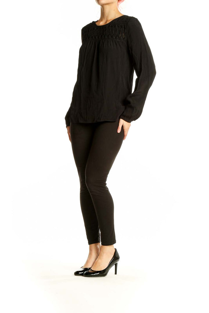 Front view of Meadow Rue black rayon blouse with crochet yoke detail