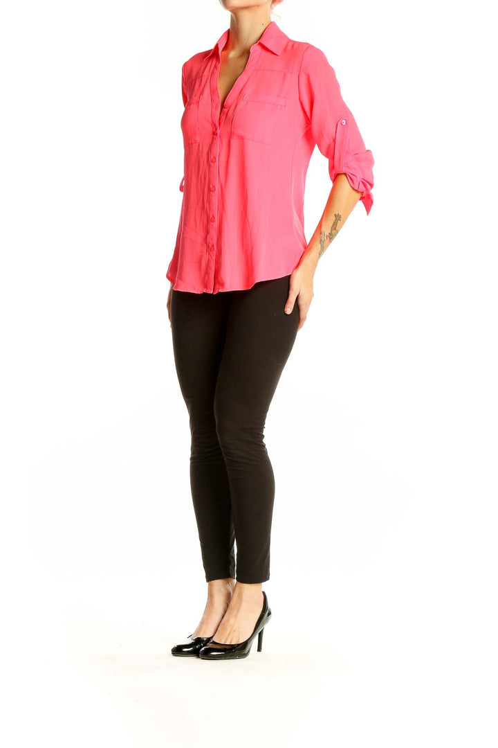 Front view of pink Express button-down blouse with chest pockets