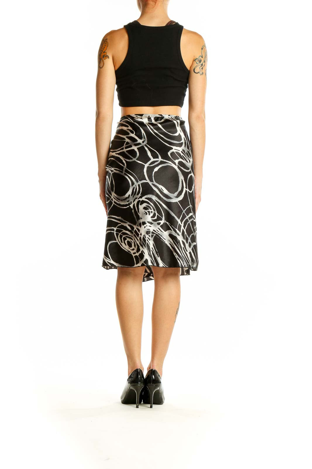 Side view of model wearing Wrapper Black and White Swirl Pattern Midi Skirt with black top