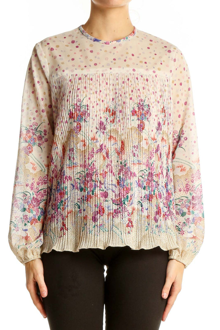 Front view of SilkRoll beige floral pleated long sleeve blouse with polka dot background